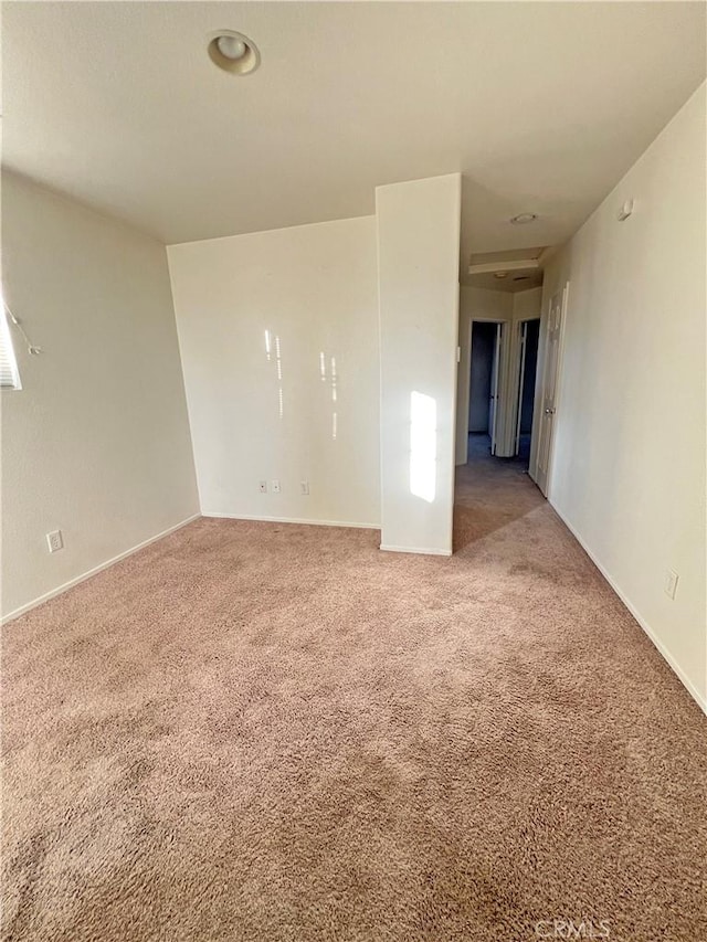 unfurnished room with light carpet