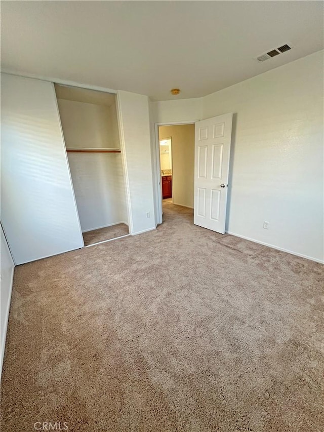 unfurnished bedroom with a closet and carpet flooring