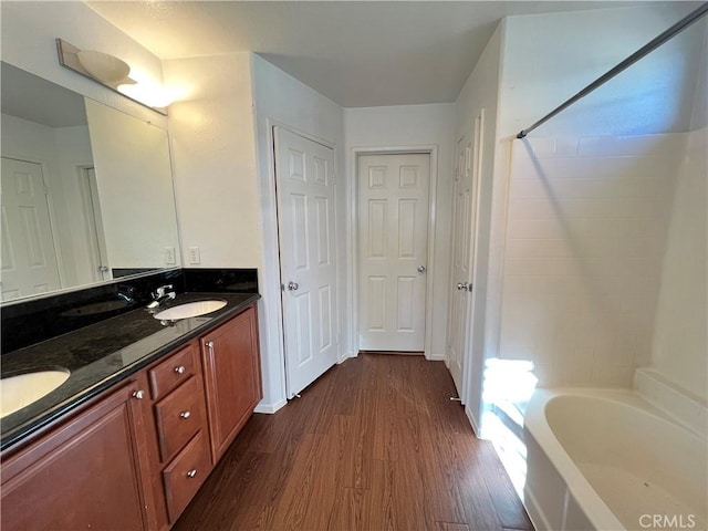 bathroom with vanity, hardwood / wood-style flooring, and  shower combination