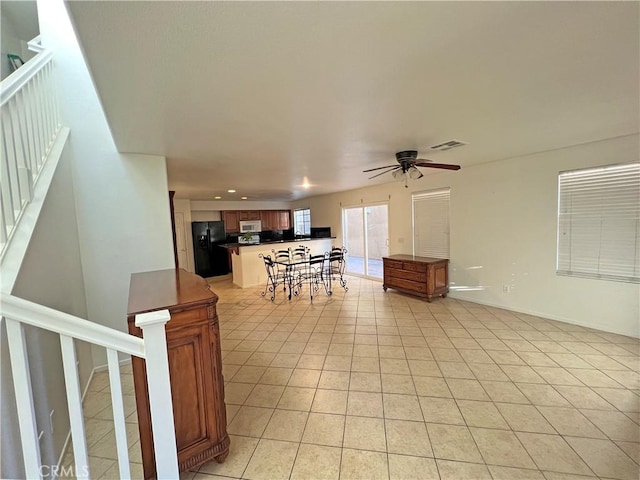 living room with ceiling fan and light tile patterned flooring