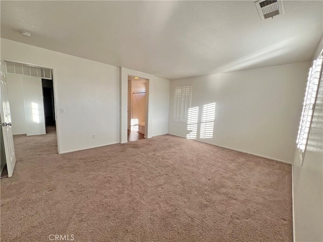 spare room featuring light colored carpet