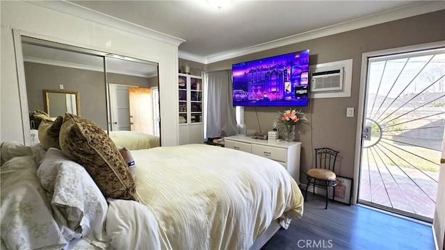 bedroom featuring hardwood / wood-style flooring, ornamental molding, a wall mounted air conditioner, and access to exterior