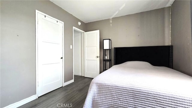 bedroom with dark hardwood / wood-style floors