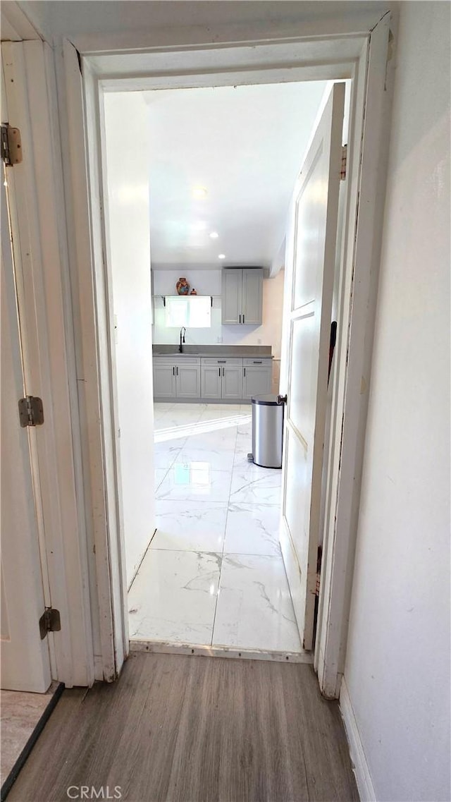 hall featuring sink and light hardwood / wood-style floors