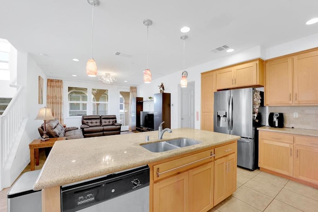 kitchen with pendant lighting, appliances with stainless steel finishes, light brown cabinetry, and sink