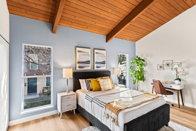 bedroom with wooden ceiling, light wood-type flooring, and vaulted ceiling with beams