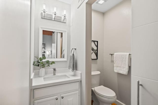 bathroom featuring vanity and toilet