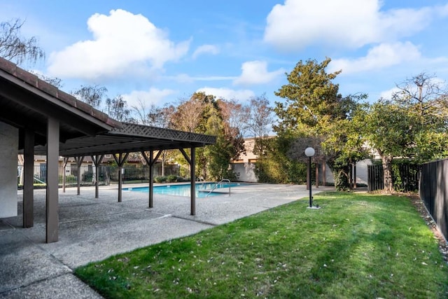 view of property's community with a pool, a patio area, and a lawn