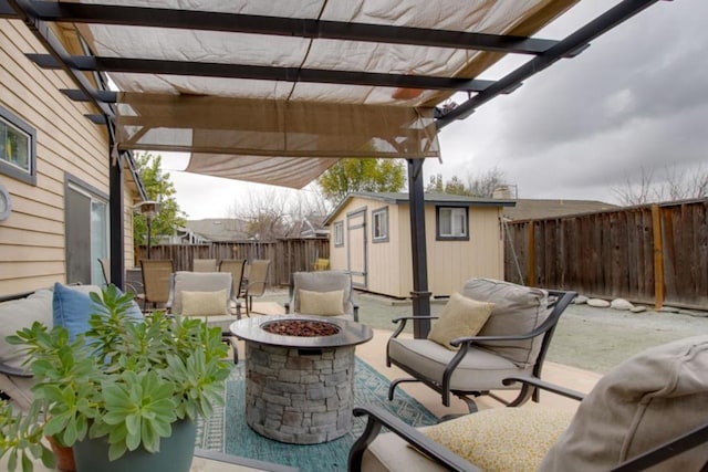 view of patio / terrace with a pergola, a shed, and a fire pit