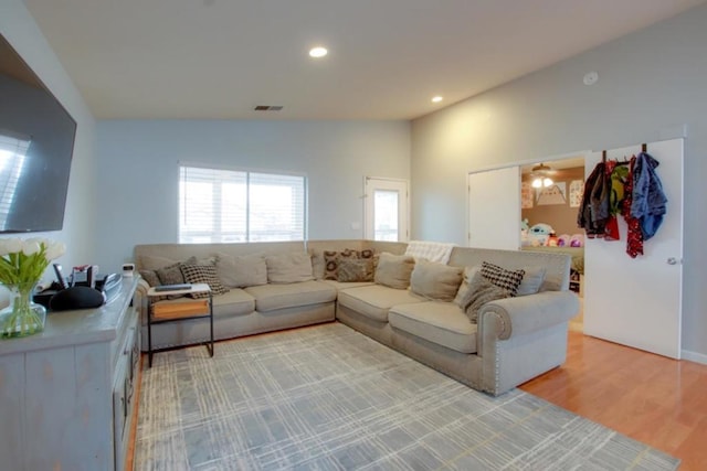 living room with vaulted ceiling and hardwood / wood-style floors