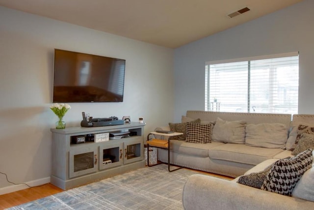 living room with lofted ceiling and light wood-type flooring