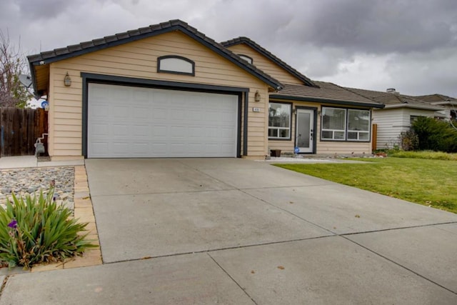 ranch-style home with a garage and a front yard