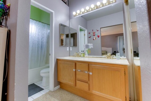 full bathroom with tile patterned flooring, vanity, shower / tub combo with curtain, and toilet