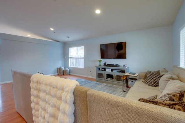 living room with vaulted ceiling and light hardwood / wood-style flooring