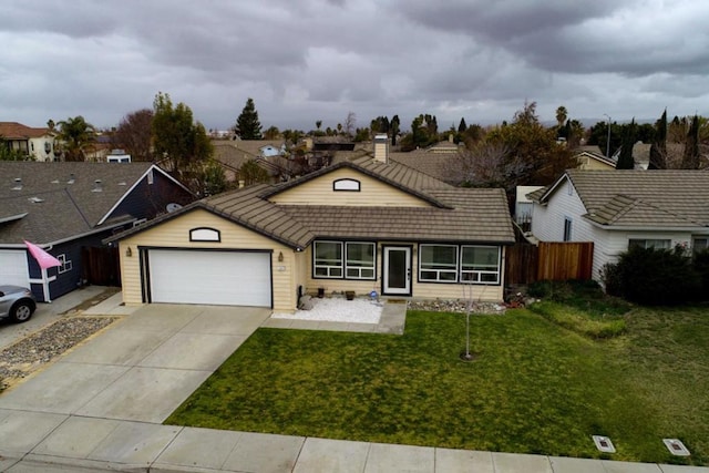 ranch-style home with a garage and a front lawn