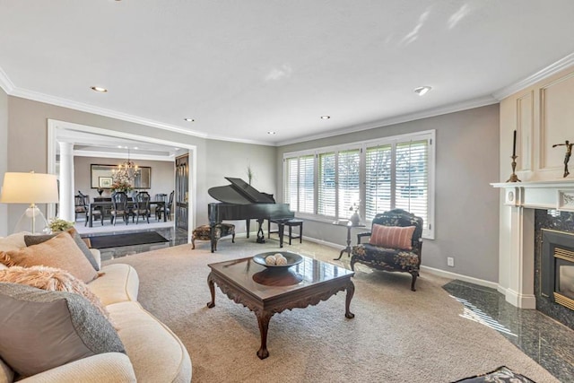 living room with a notable chandelier, a fireplace, and ornamental molding