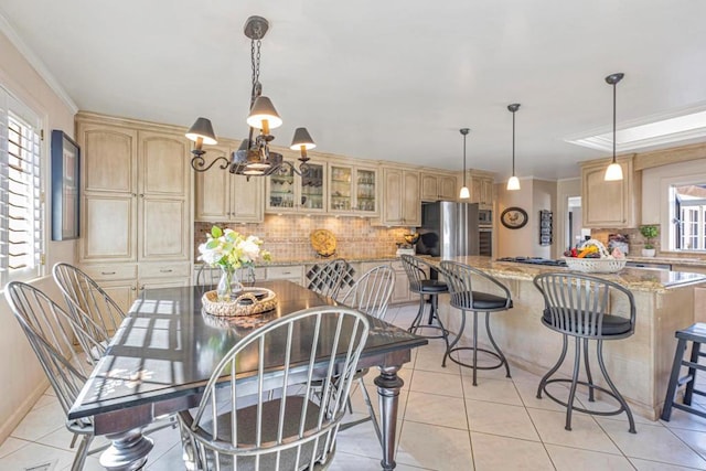 tiled dining room featuring plenty of natural light and ornamental molding