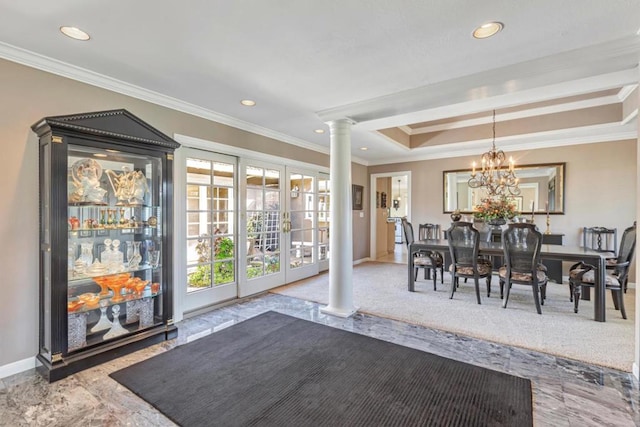 carpeted dining area featuring ornate columns, ornamental molding, an inviting chandelier, and french doors