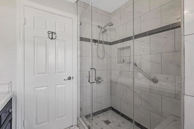 bathroom featuring vanity and an enclosed shower