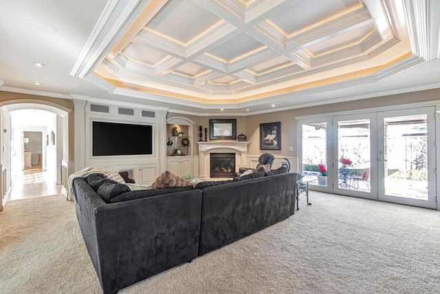 carpeted living room featuring crown molding, coffered ceiling, and french doors