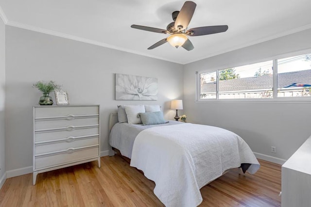 bedroom with crown molding, ceiling fan, and light hardwood / wood-style flooring