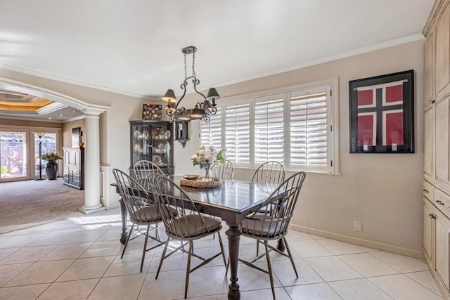 tiled dining space with crown molding, a chandelier, and decorative columns