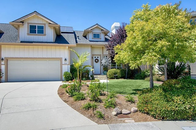 view of front of property featuring a garage and a front lawn