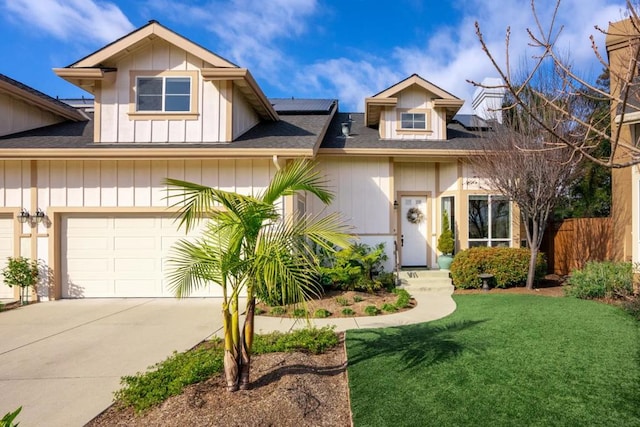 view of front of property featuring a garage and a front lawn