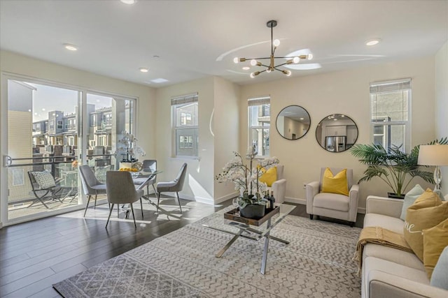 living room with hardwood / wood-style floors and a notable chandelier