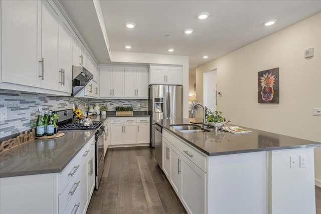 kitchen with white cabinetry, an island with sink, stainless steel appliances, and sink