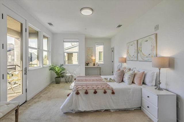 bedroom with connected bathroom and light colored carpet