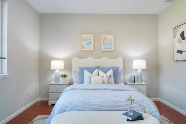 bedroom with dark hardwood / wood-style floors