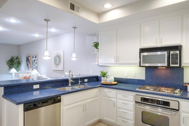 kitchen featuring white cabinetry, stainless steel appliances, decorative light fixtures, and sink