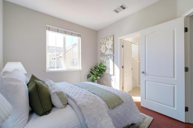 bedroom with dark hardwood / wood-style floors