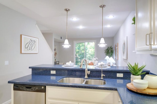 kitchen featuring dishwasher, sink, pendant lighting, and white cabinets