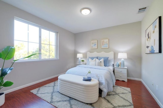 bedroom with dark hardwood / wood-style floors