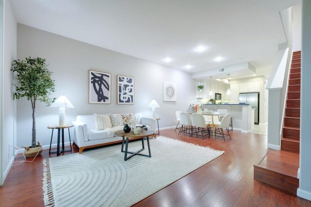 living room with dark hardwood / wood-style flooring