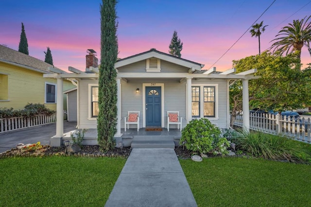 bungalow-style house with a yard and a porch