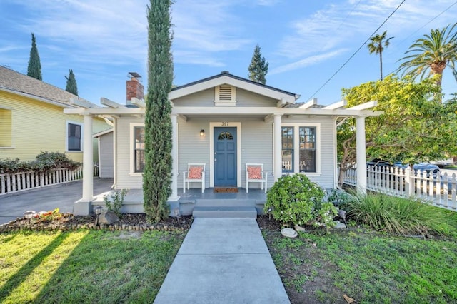 bungalow-style home with a front yard and covered porch