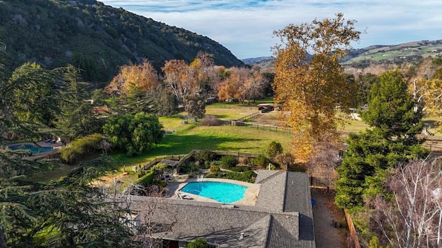 view of swimming pool with a mountain view