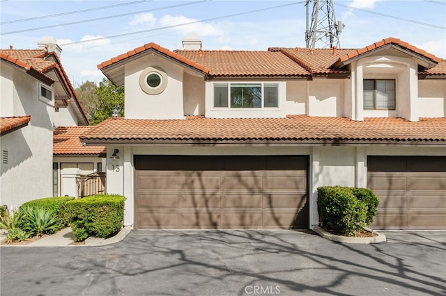 mediterranean / spanish-style home featuring a garage