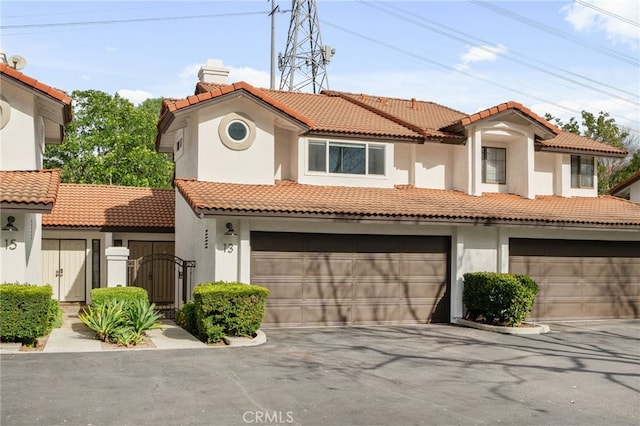 mediterranean / spanish home featuring a garage