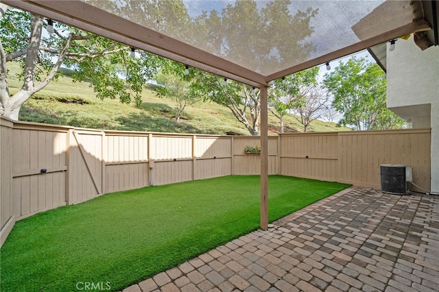 view of yard featuring a patio and central air condition unit