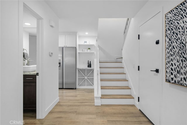 staircase featuring wood-type flooring