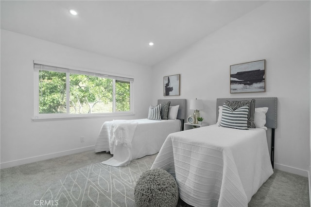 carpeted bedroom with lofted ceiling