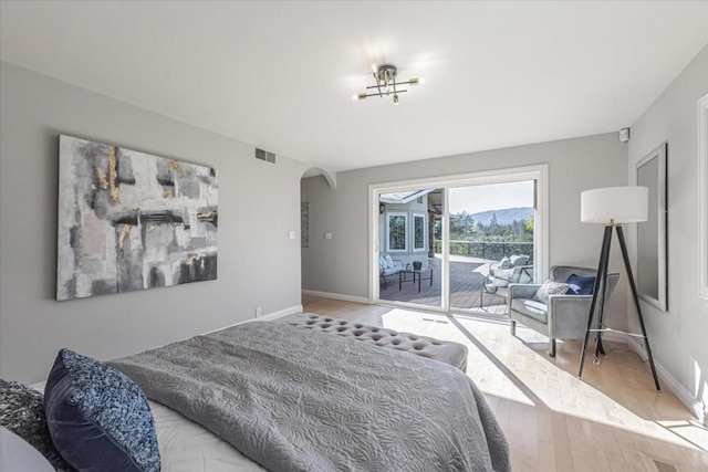 bedroom featuring hardwood / wood-style floors and access to outside