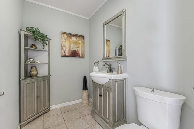 bathroom with vanity, tile patterned floors, crown molding, and toilet