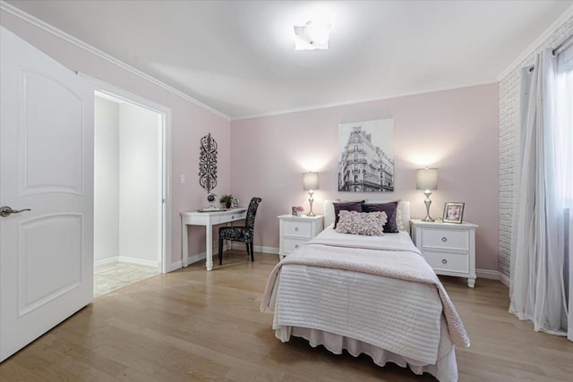 bedroom featuring crown molding and light hardwood / wood-style flooring