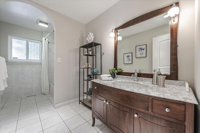 bathroom featuring tile patterned floors, vanity, and shower / bath combo with shower curtain