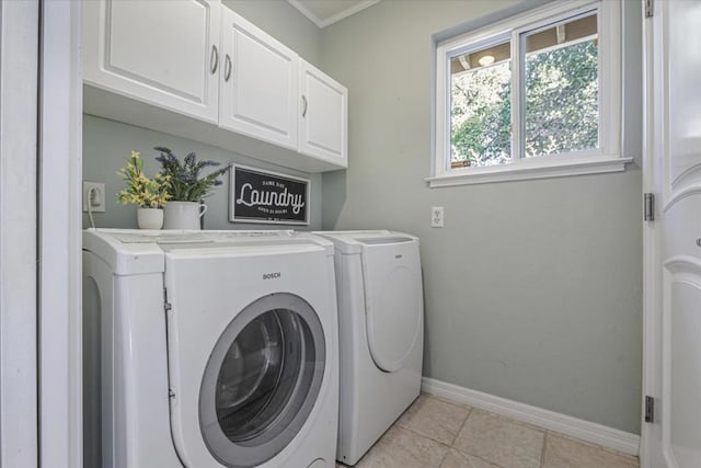 clothes washing area with separate washer and dryer, ornamental molding, cabinets, and light tile patterned flooring